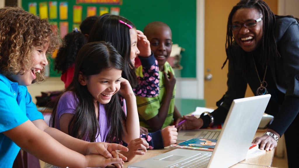 Stock Teacher and students on computers 4 104737316